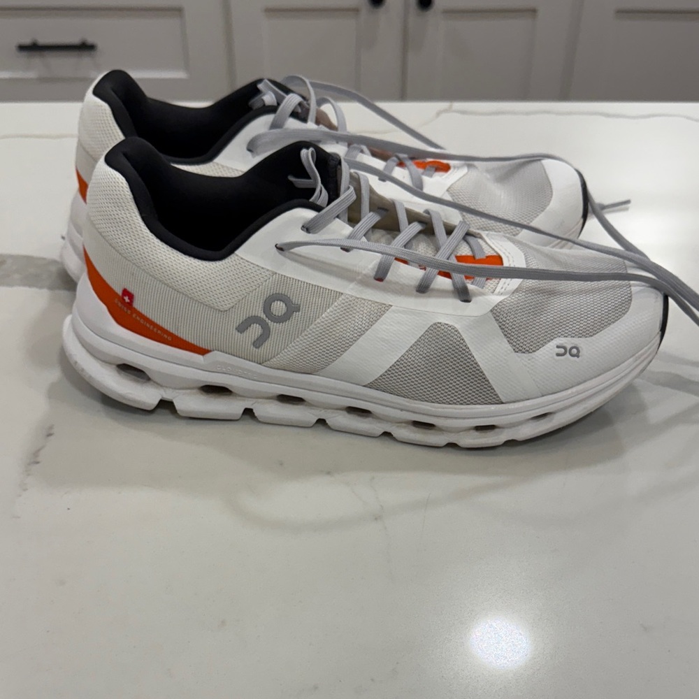 On Running White and Orange Athletic Shoes